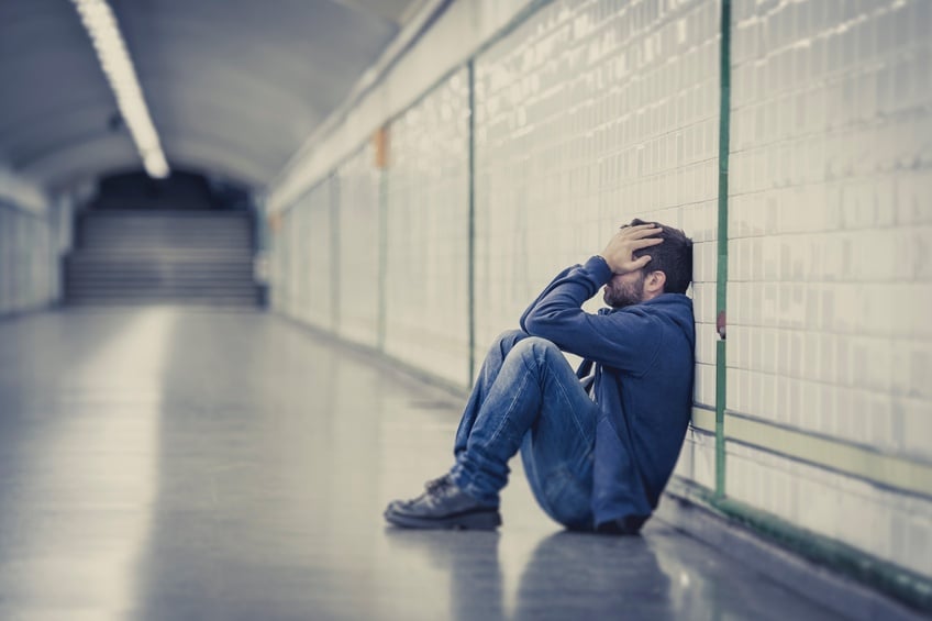 A depressed man in a metro tunnel