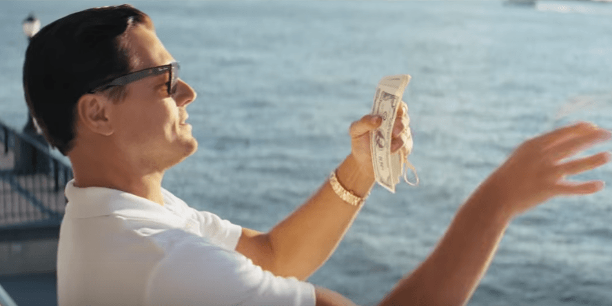 Wolf of Wall Street character with money in hand