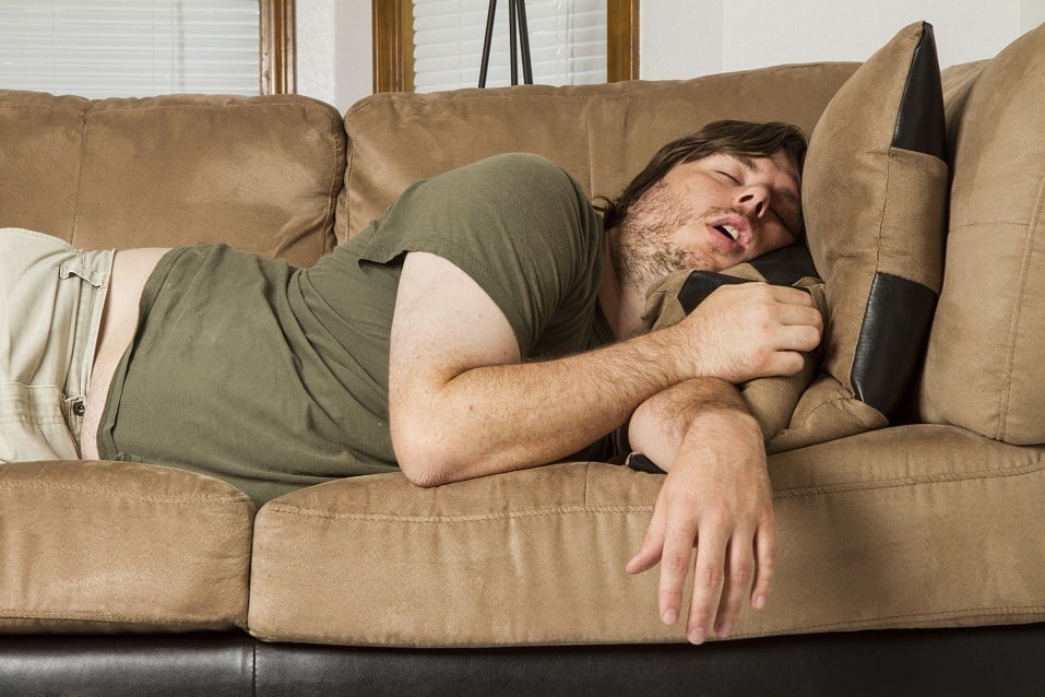 Fat guy sleeping on the couch