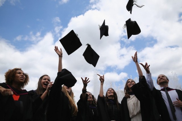 Students throw their caps in the air ahead of their graduation ceremony at the Royal Festival Hall on July 15, 2014 in London, England. Students of the London College of Fashion, Management and Science and Media and Communication attended their graduation ceremony at the Royal Festival Hall today. (Photo by Dan Kitwood/Getty Images)