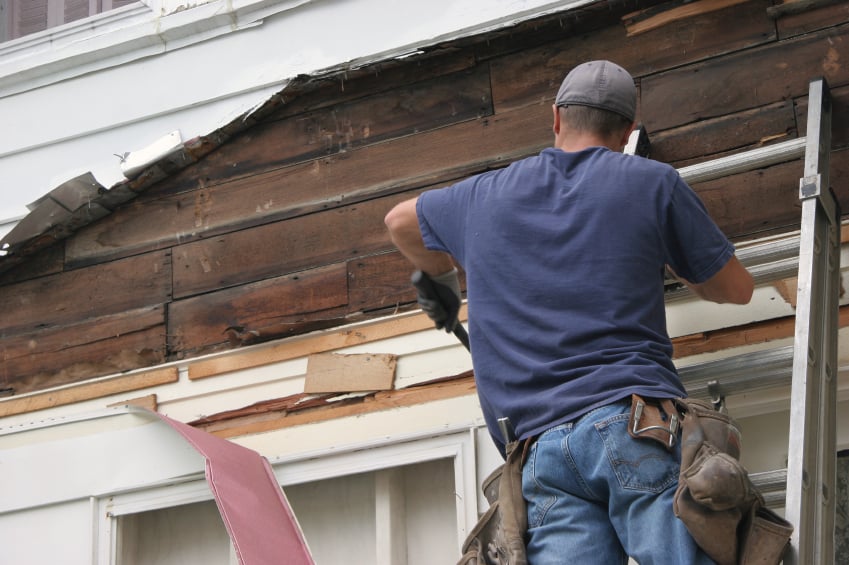 man working on house