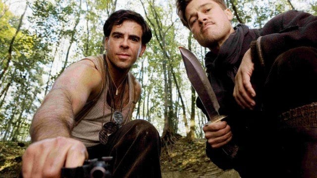 Eli Roth and Brad Pitt holding knives to the ground in Inglourious Basterds