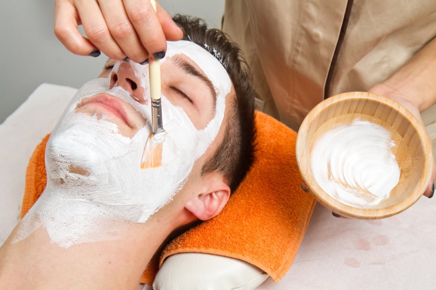 young man in spa having cosmetic face mask