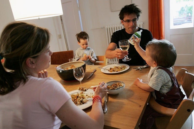 A family eat dinner at home, where it's easier to control your diet