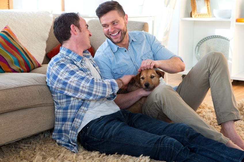 Same sex male couple sitting on the floor