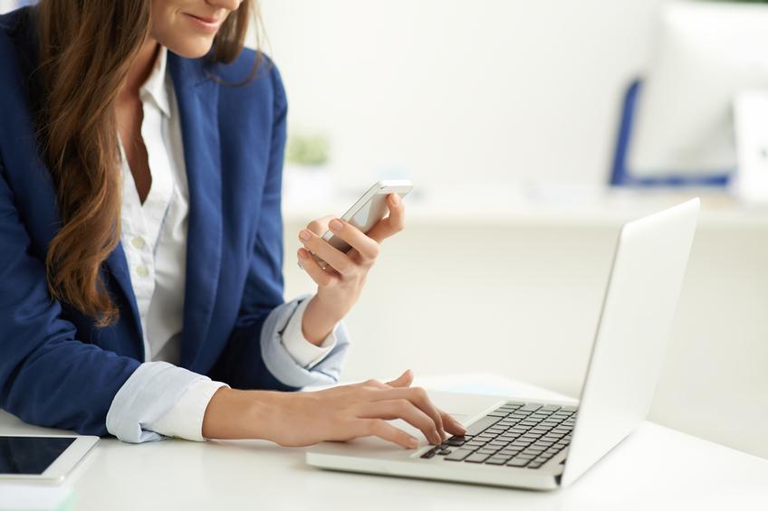 Business lady texting and using laptop