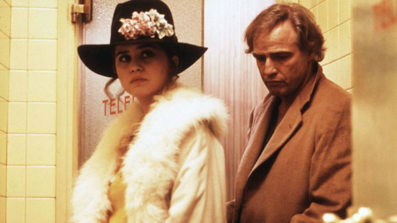 A woman in a black flowered hat with a white fur jacket Last Tango in Paris