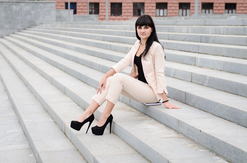 brunette wearing white suite and high heels