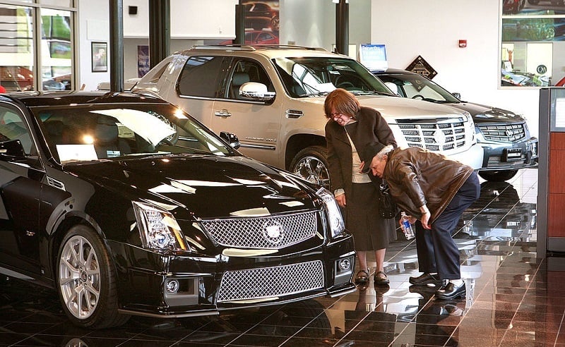 LINCOLNWOOD, IL - MAY 13: Customers look over Cadillacs offered for sale at a GM dealership May 13, 2009 in Lincolnwood, Illinois. In an attempt to shore up the industry General Motors announced plans to cut 2600 dealerships while Chrysler has made plans to eliminate about 850.