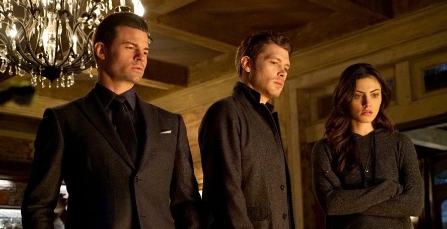 Elijah, Klaus, and Hayley stand together in a room looking down on The Originals.