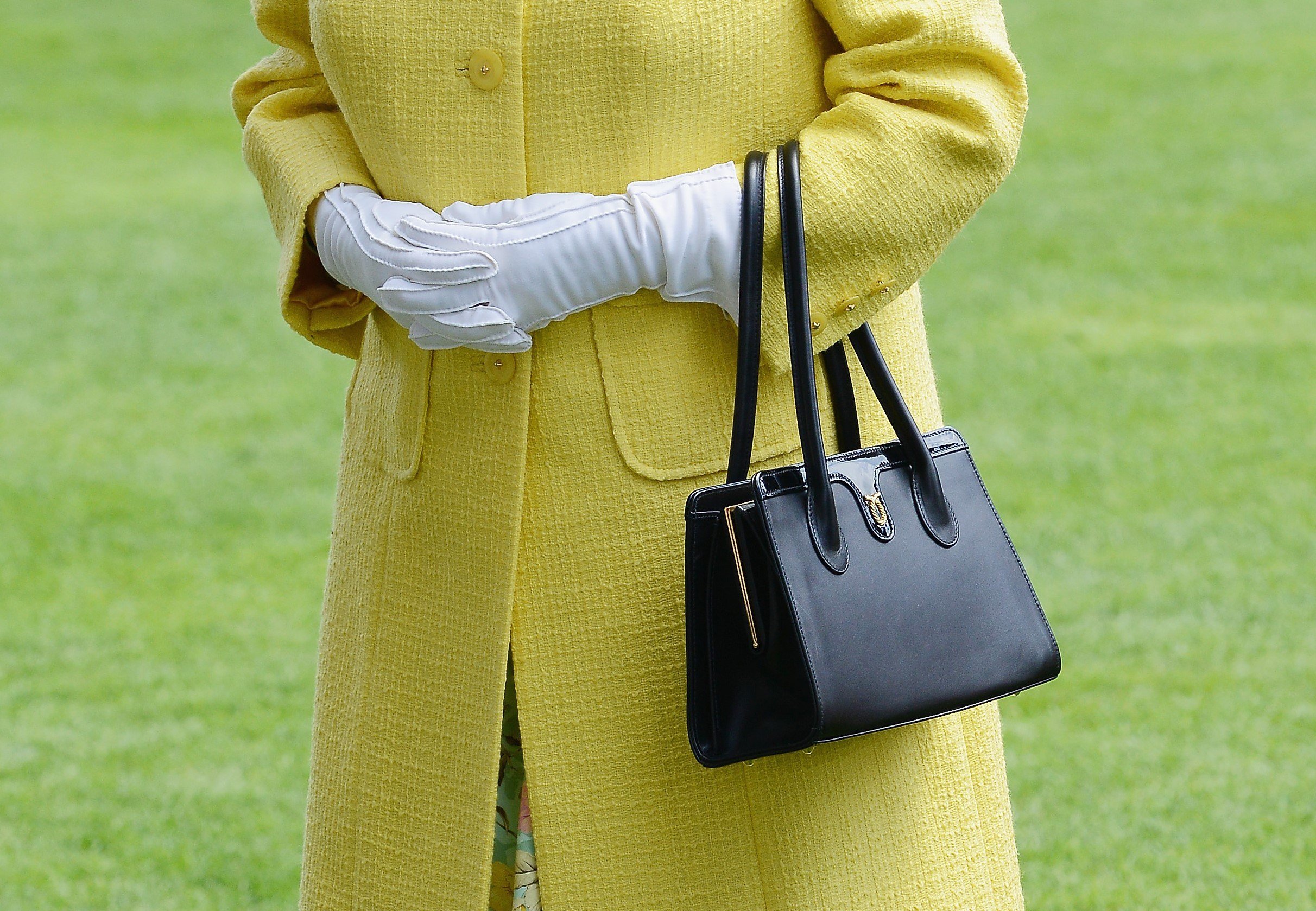 Why Does the Queen Always Carry a Purse? It Serves Multiple Purposes
