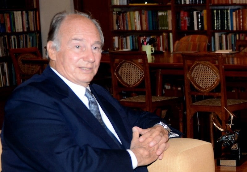 Prince Shah Karim Al Husseini sits in a chair