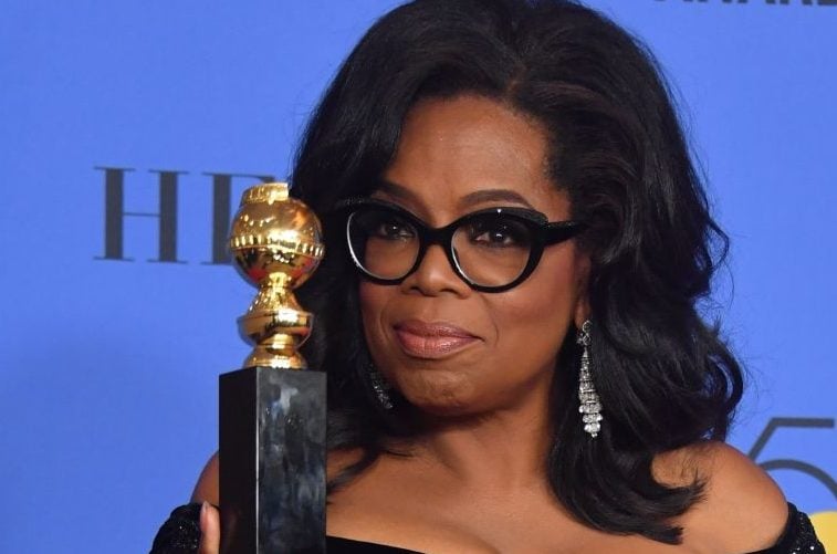 Actress and TV talk show host Oprah Winfrey poses with the Cecil B. DeMille Award during the 75th Golden Globe Awards