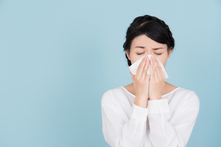 Woman sneezing