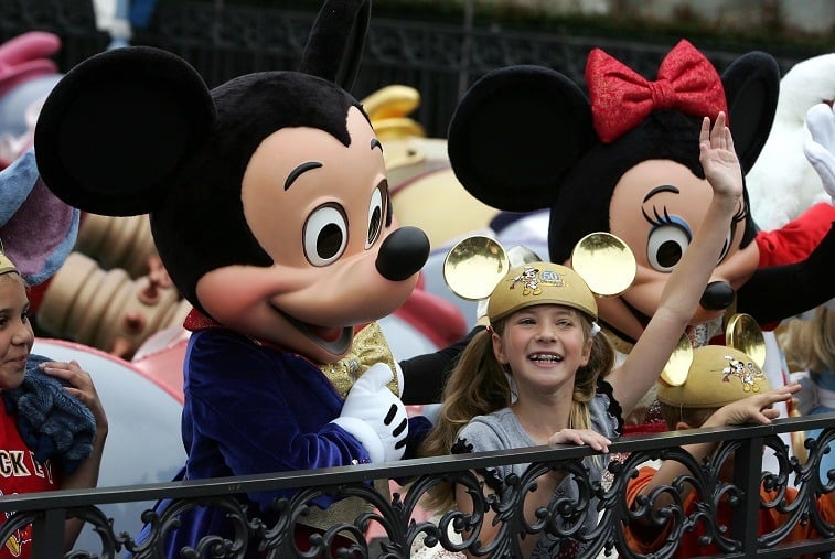 Mickey Mouse and Caroline Sunshine take part in the unveiling of the "Golden Dumbo" to commemorate the Disneyland 50th Anniversary Celebration at Disneyland Park on May 4, 2005 in Anaheim, California.