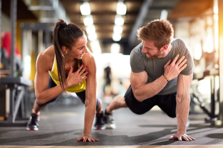 Woman and man training in gym