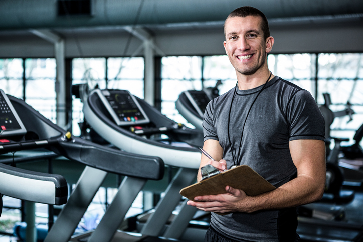 Personal trainer writing on the clipboard