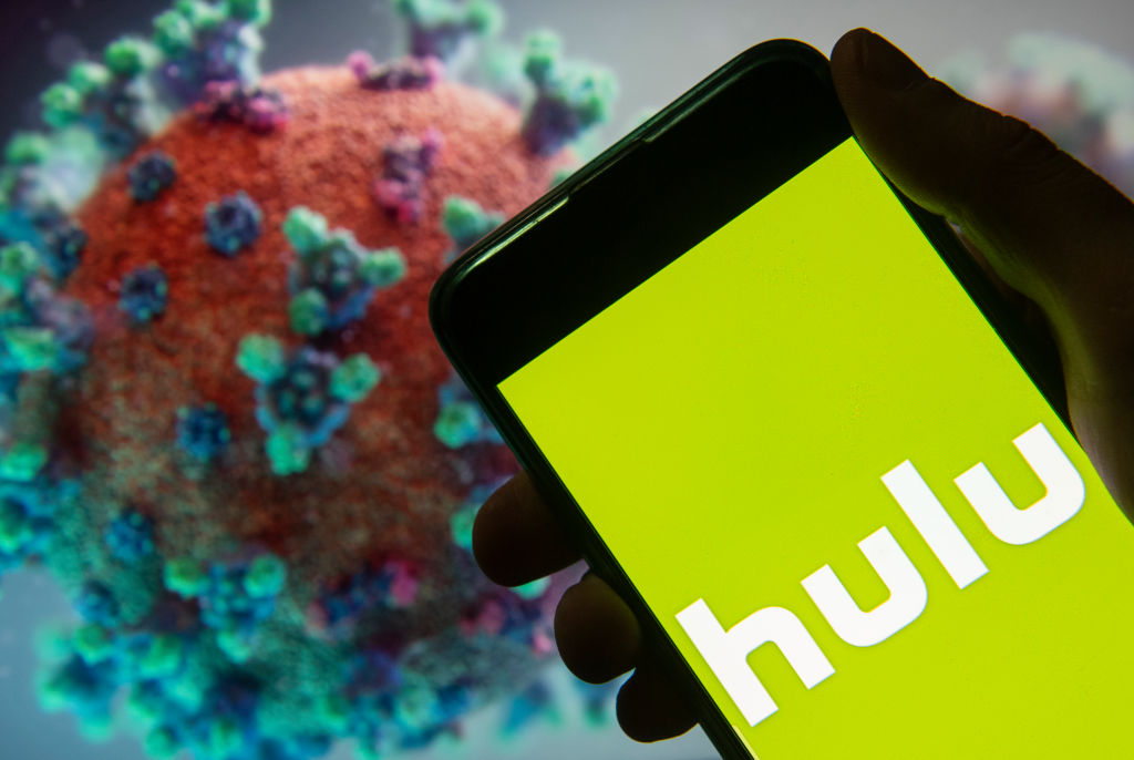 Hulu logo on a smart phone in front of coronavirus