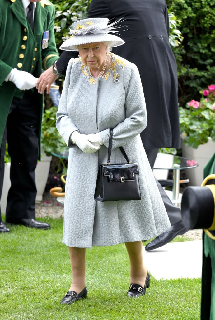 Why The Queen and The Royal Family always carry a handbag or clutch bag –  The Sun
