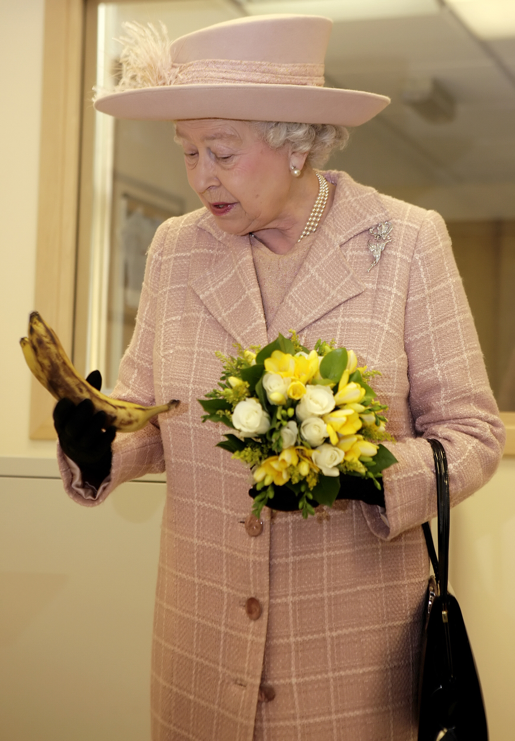 Queen Elizabeth II holding bananas