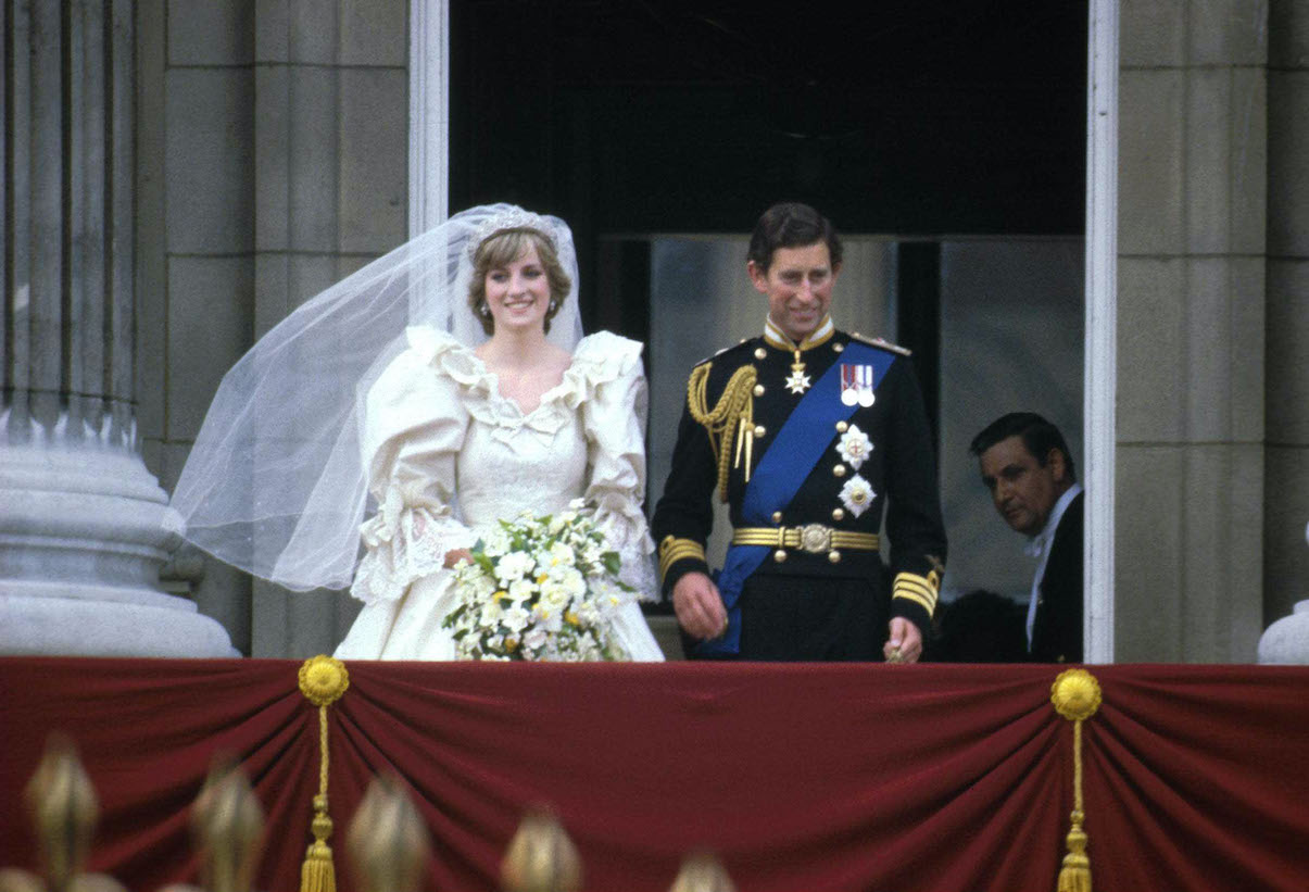Princess Diana and Prince Charles stand on the balcony of Buckingham Palace after their royal wedding