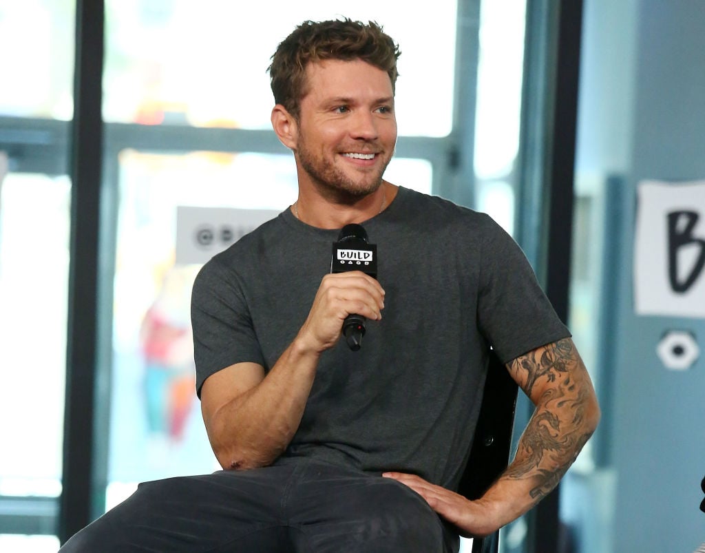 Ryan Phillippe smiling, holding a microphone