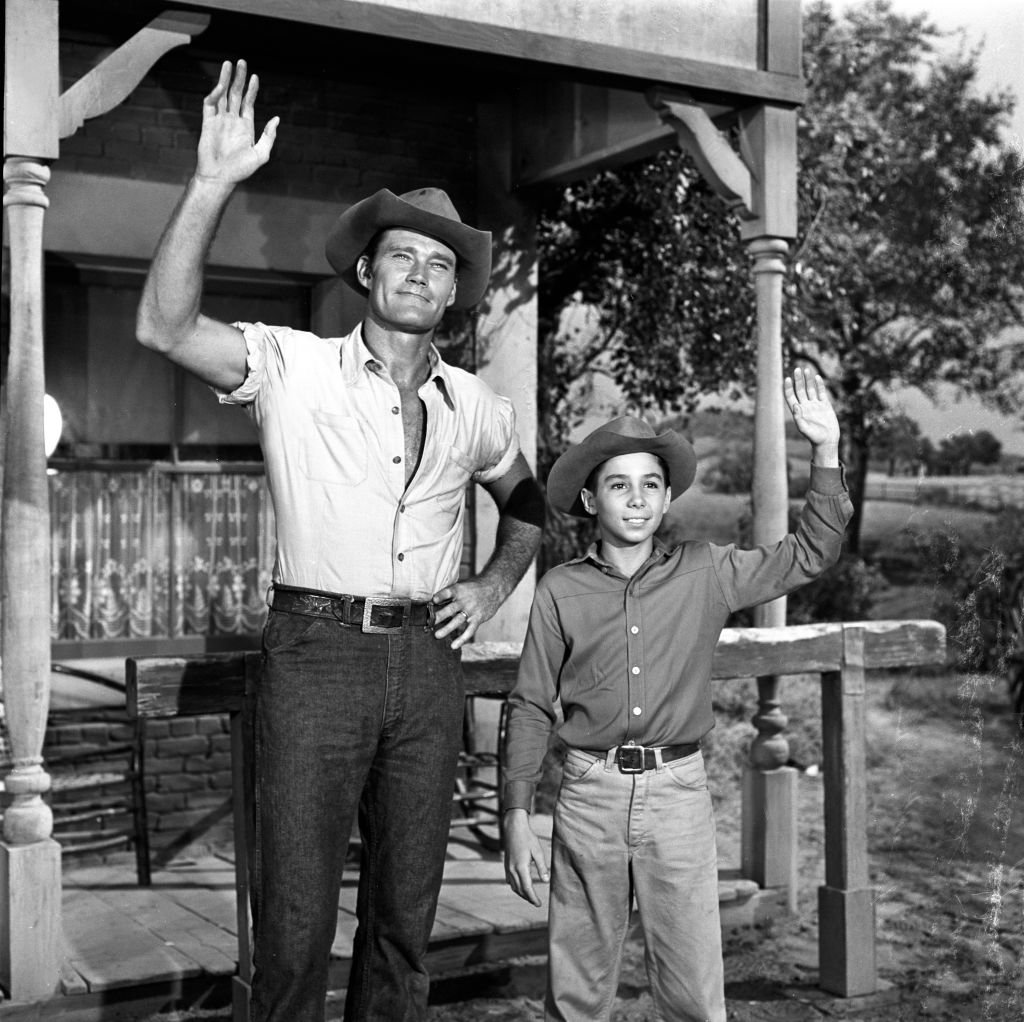 (L-R) Chuck Connors as Lucas McCain and Johnny Crawford as Mark McCain