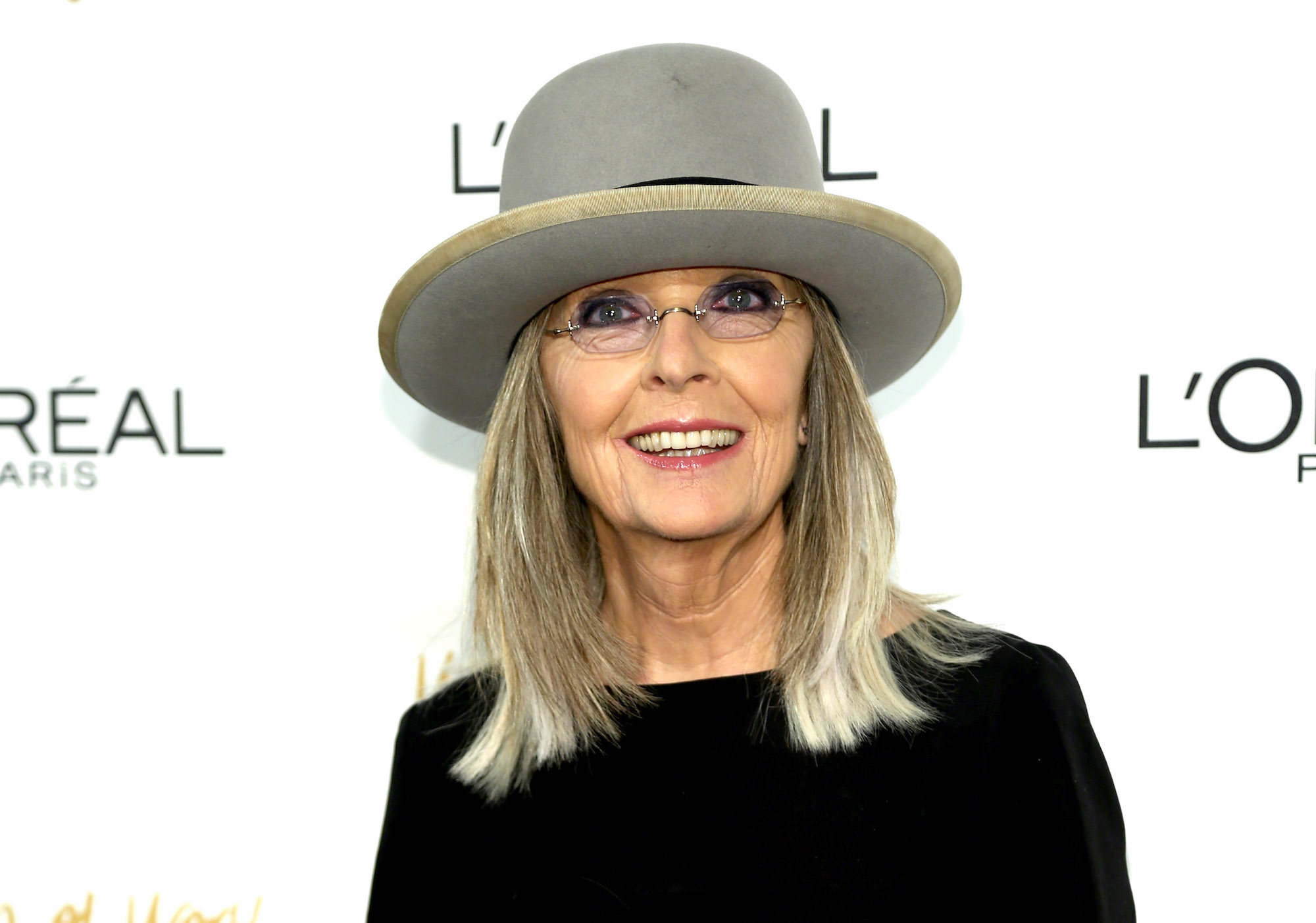 Diane Keaton smiling in front of a white background