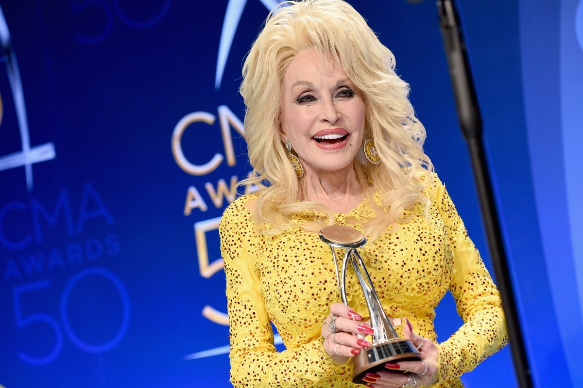 Dolly Parton poses with award backstage during the 50th annual CMA Awards at the Bridgestone Arena on November 2, 2016 in Nashville, Tennessee