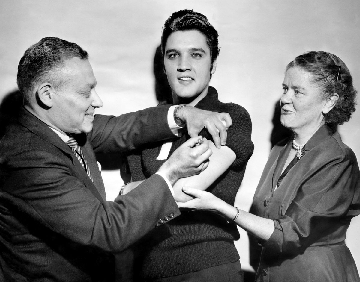 Elvis Presley receiving a polio vaccination from Leona Baumgartner and Harold Fuerst at CBS Studio 50 in New York City before 'The Ed Sullivan Show' in 1956