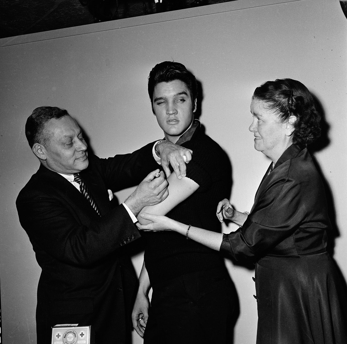 Elvis Presley getting the polio vaccine from two clinicians in 1956 before his performance on 'The Ed Sullivan Show'