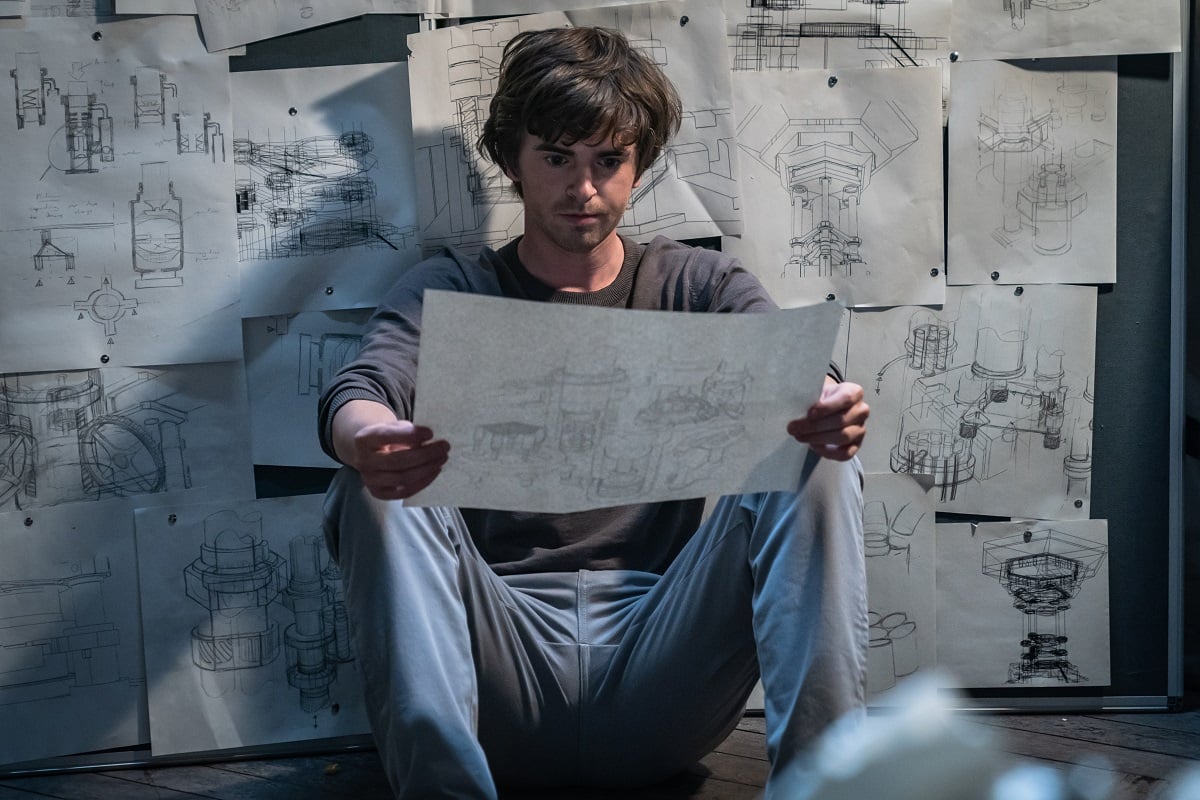 Freddie Highmore examining blueprints in a still from 'The Vault' 