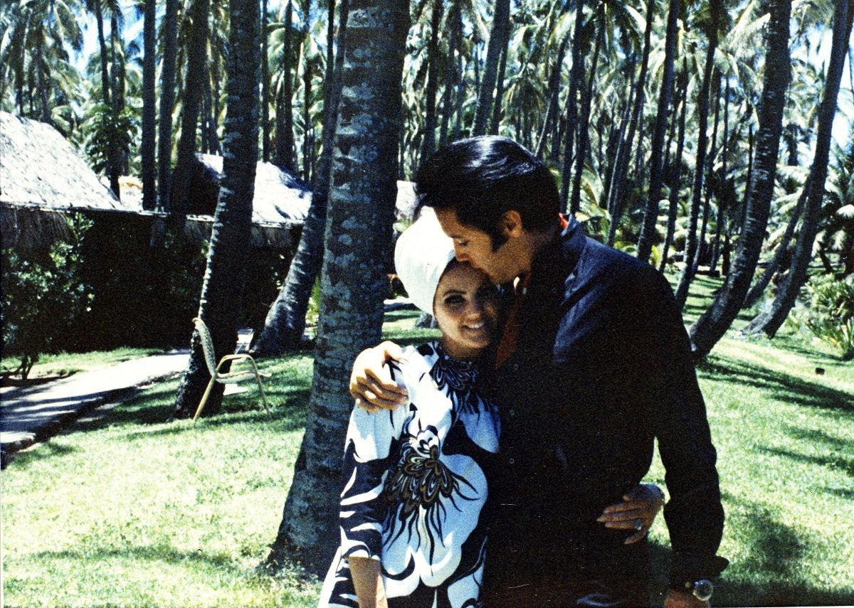 Priscilla Presley and Elvis Presley cuddling outside in Hawaii, California