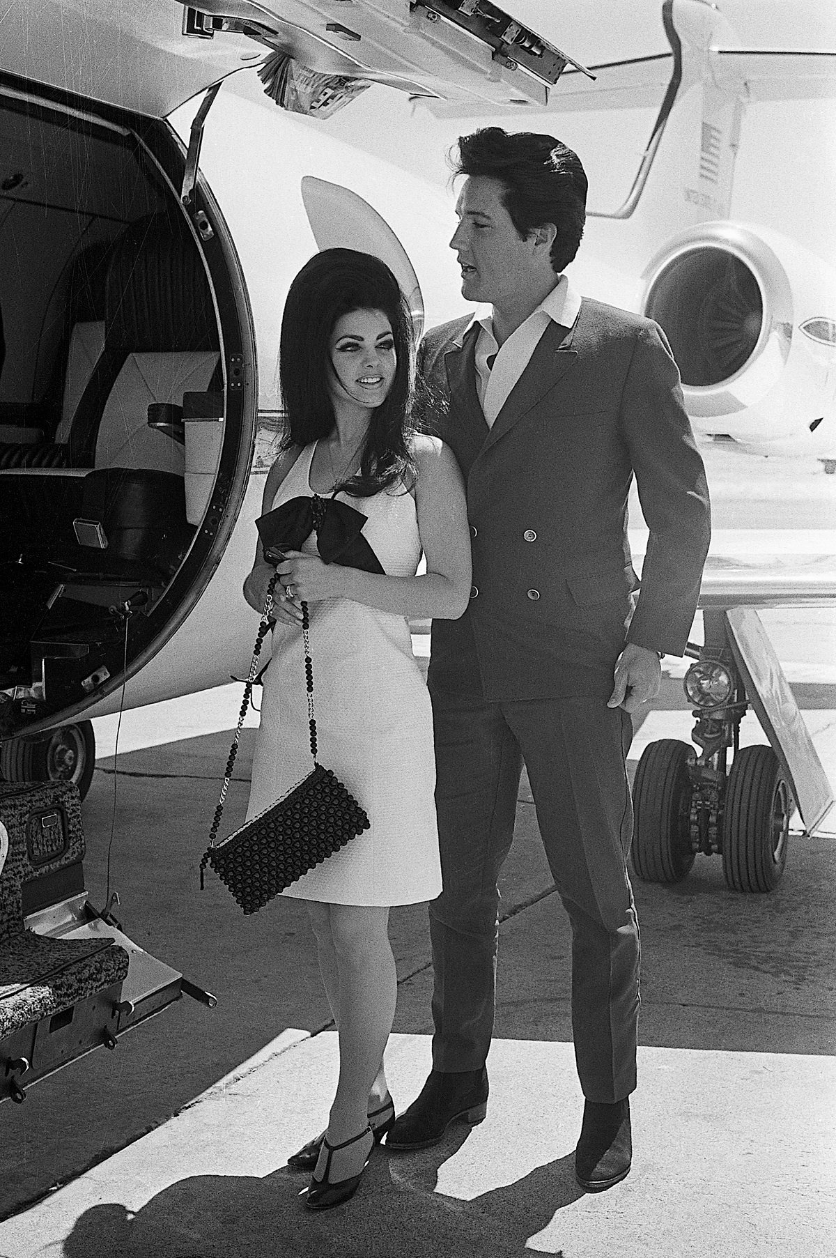  Elvis Presley and his bride, Priscilla Ann Beaulieu smile happily as they prepare to board a chartered jet airplane after their marriage at the Aladdin Hotel in 1967