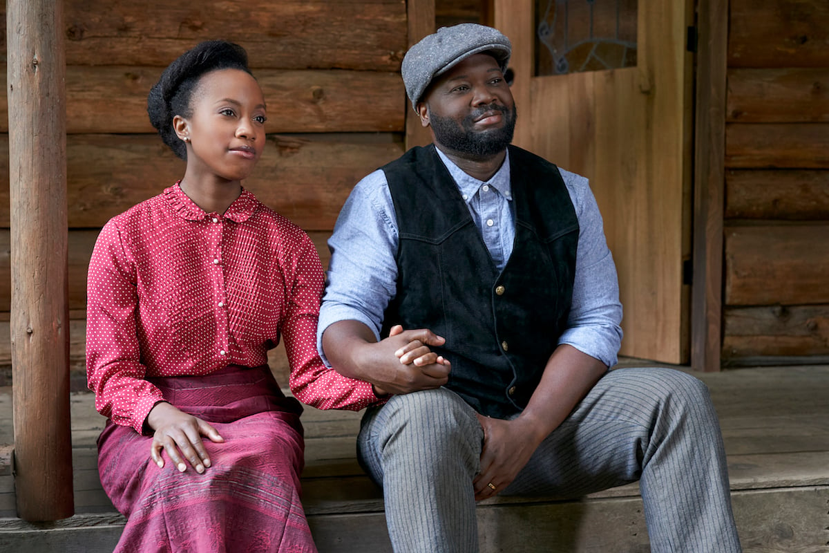 Minnie and Joseph Canfield sitting on steps holding hands in When Calls the Heart