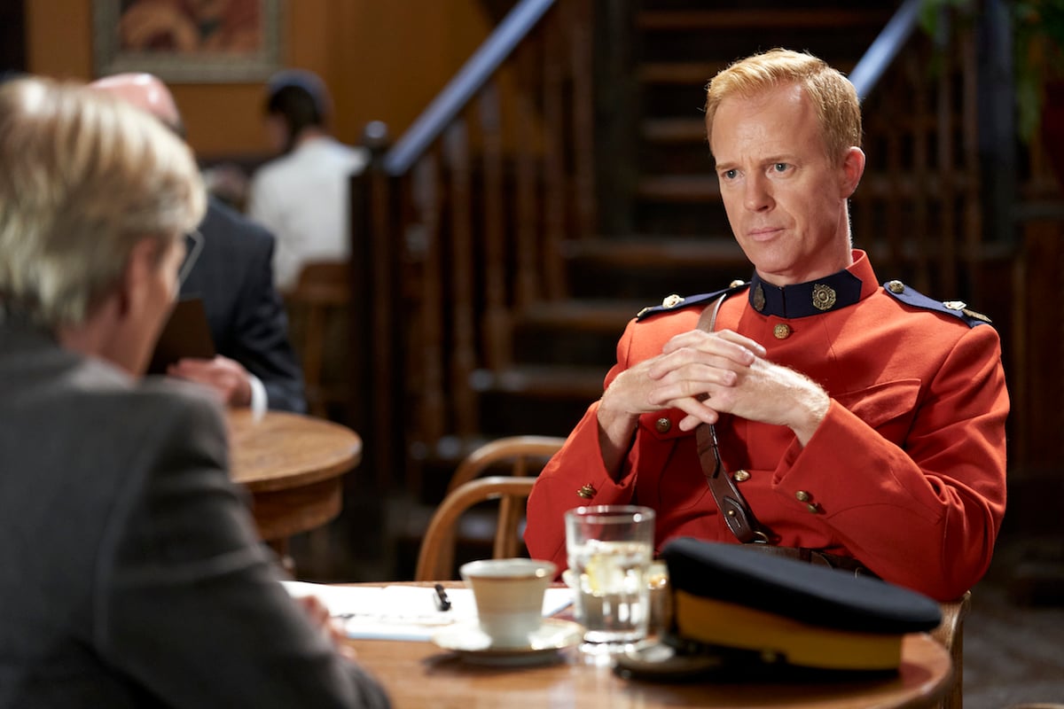 Superintendent Hargraves sitting opposite Bill at a table