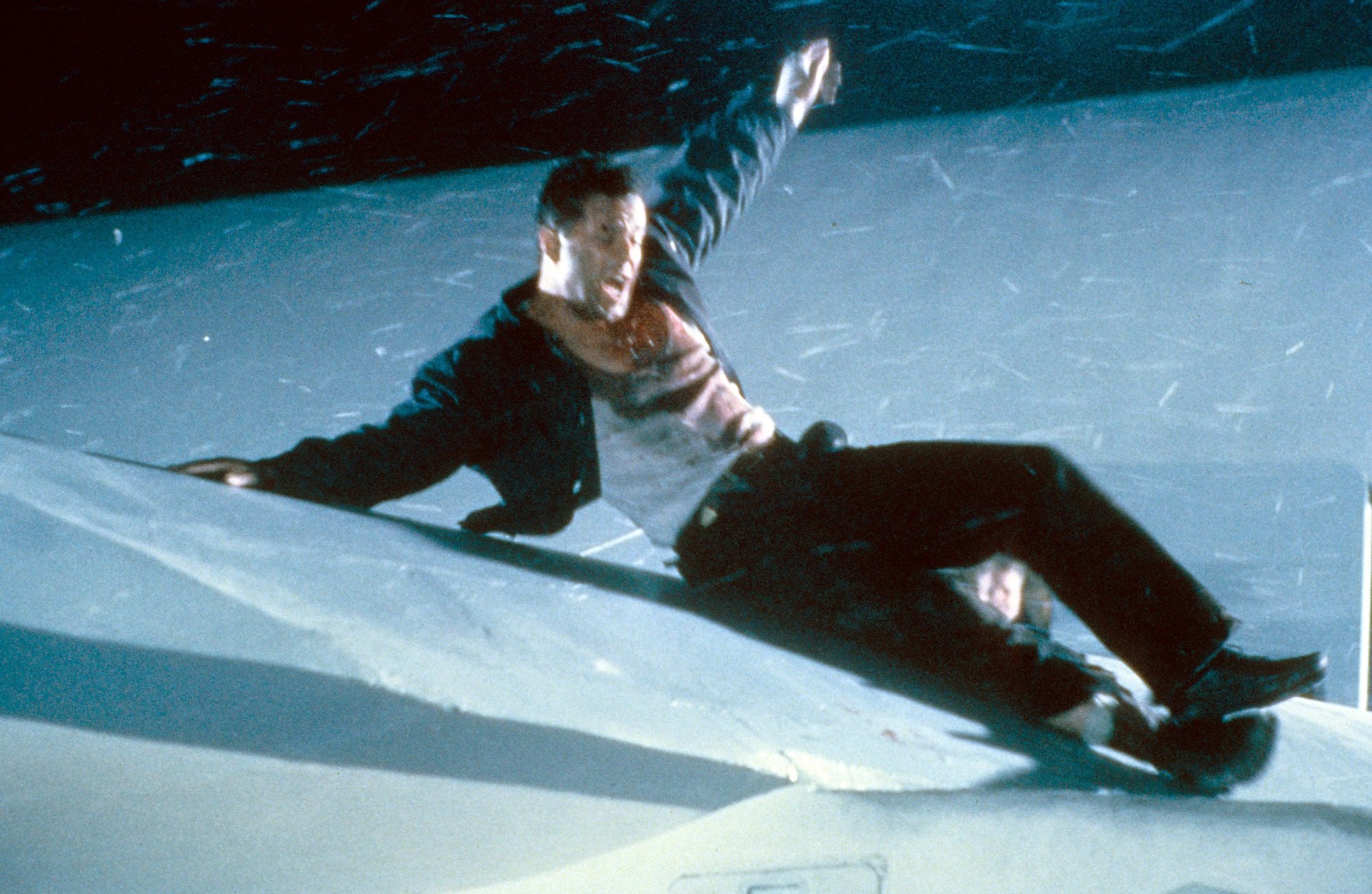 Bruce Willis slides on the wing of an airplane in Die Hard 2