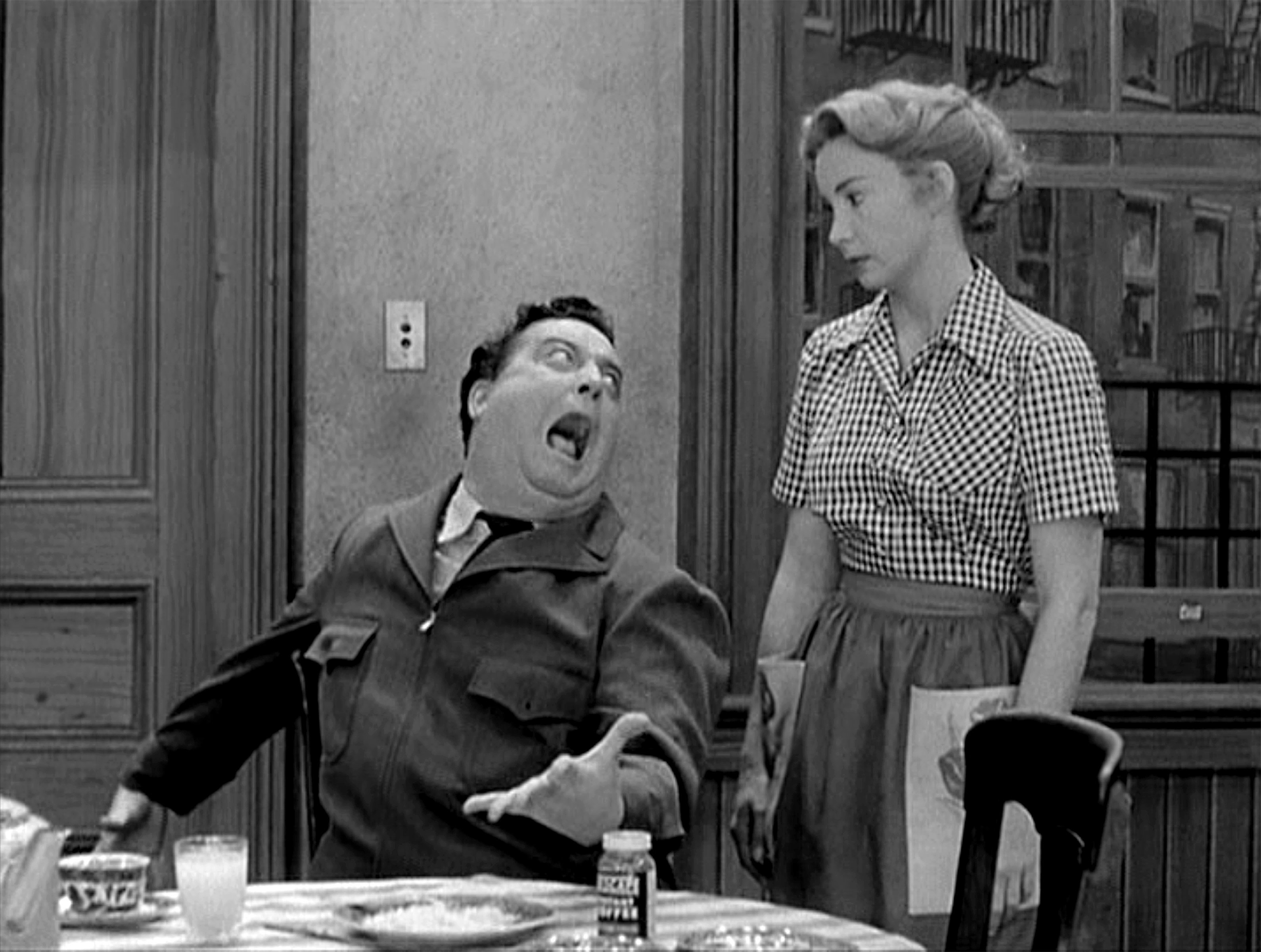 Jackie Gleason as Ralph Kramden and Audrey Meadows as Alice Kramden in a scene from 'The Honeymooners' television comedy, 1955