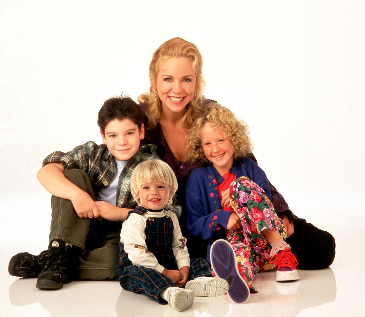 A group photo of the Grace Under Fire cast with white background