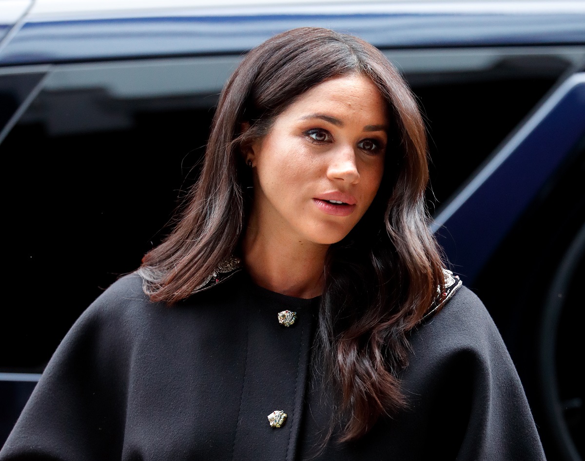 Meghan Markle wearing a black coat on a visit to New Zealand House