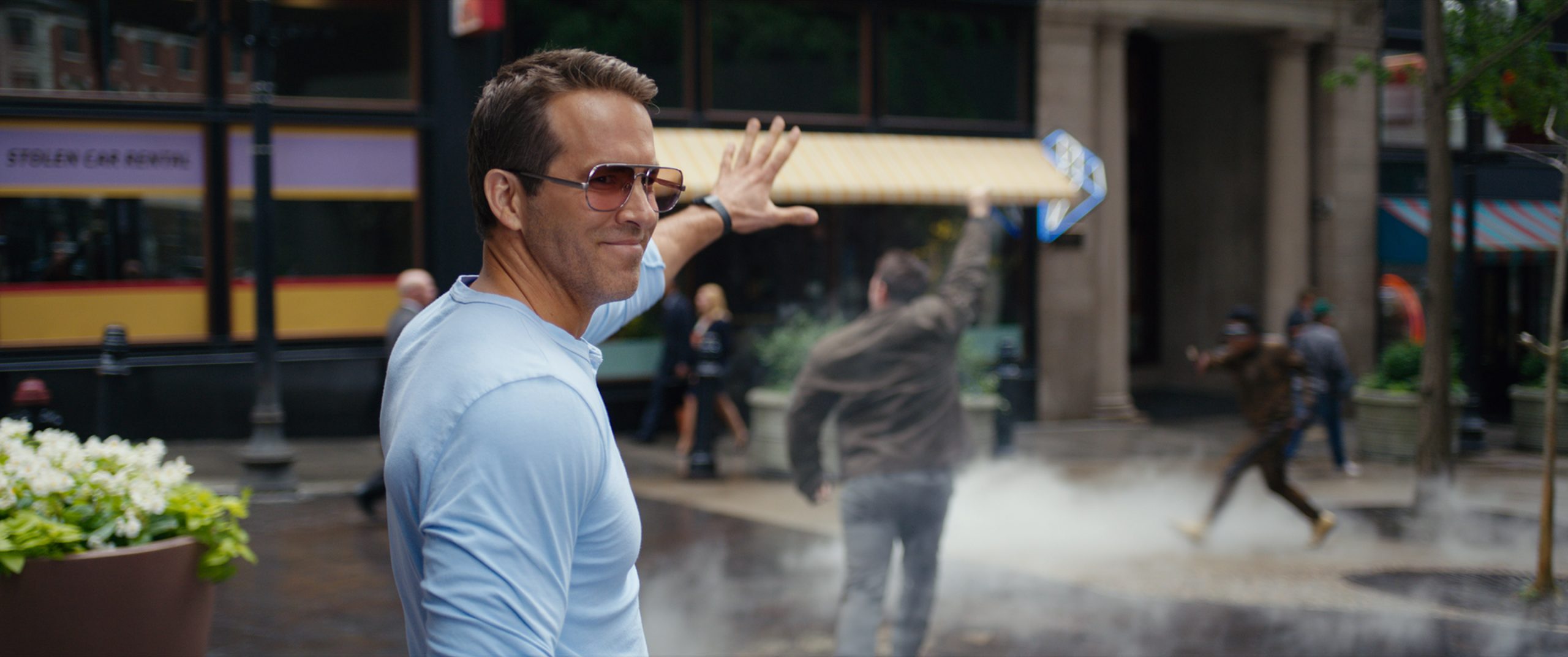 https://www.cheatsheet.com/wp-content/uploads/2021/08/Ryan-Reynolds-holds-his-hand-up-in-Free-Guy-scaled.jpg