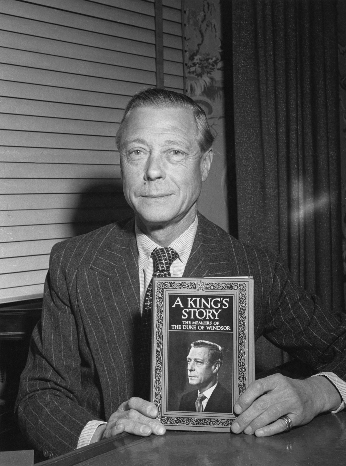 The Duke of Windsor formerly King Edward VIII holding his memoirs 'A King's Story The Memoirs of the Duke of Windsor'