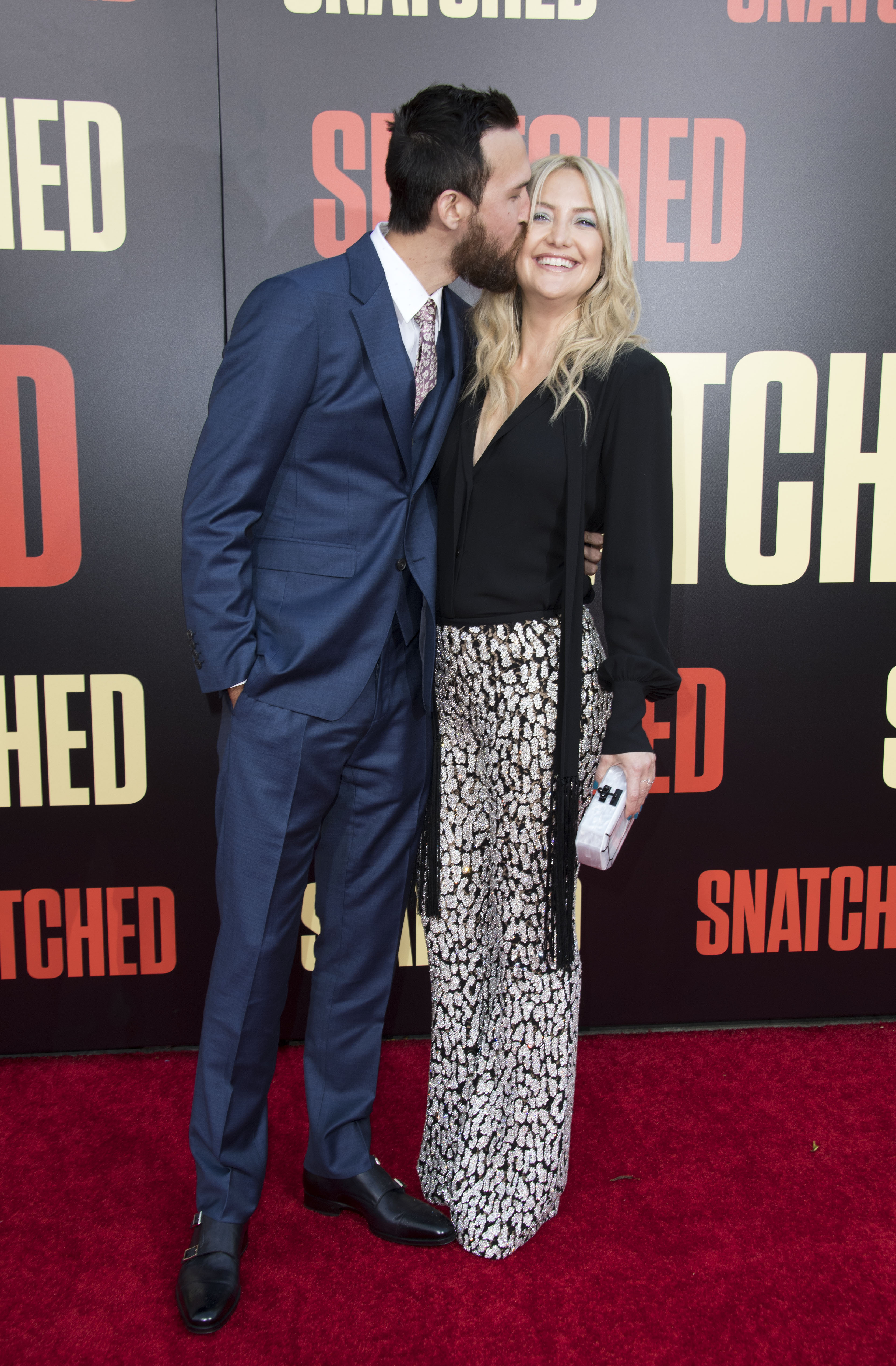 Danny Fujikawa kissing Kate Hudson's cheek on the red carpet at the world premiere of 'Snatched