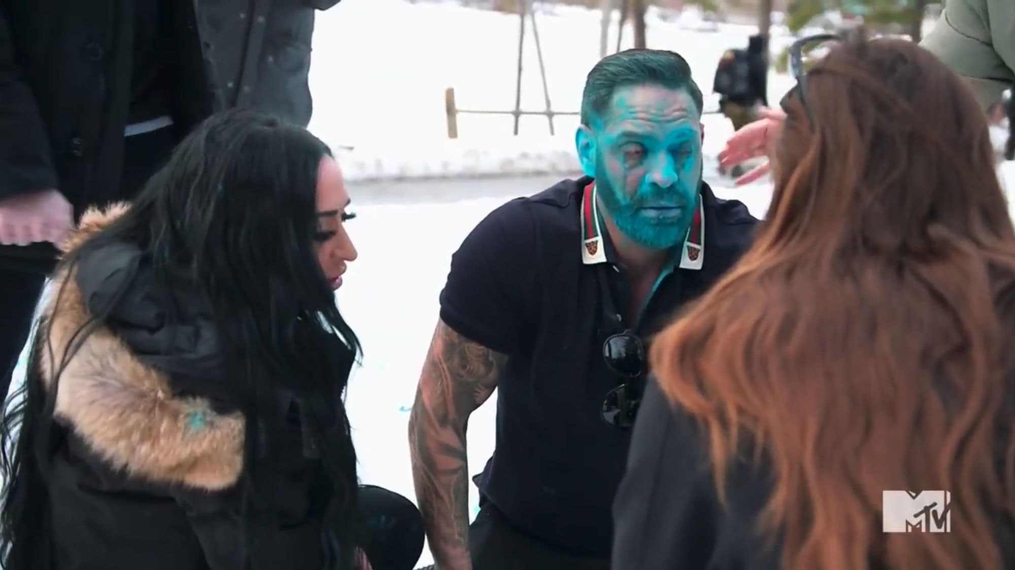 Angelina Larangeira, Chris Larangeira covered in blue powder and being tended to by a medic in the season 4 finale of 'Jersey Shore: Family Vacation'