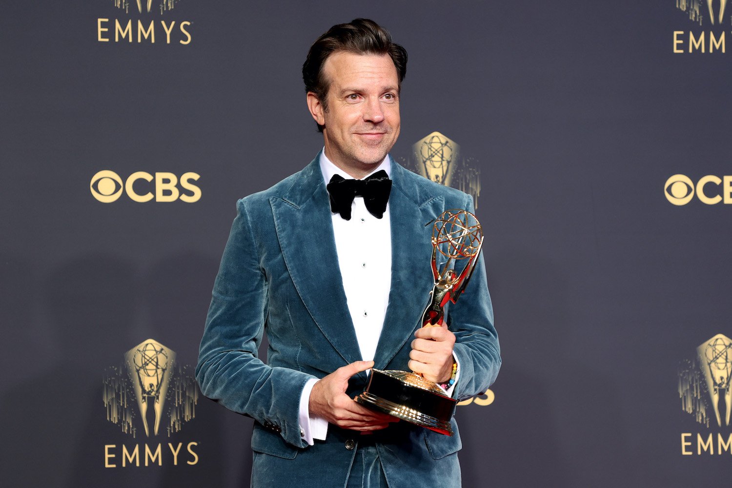 Jason Sudeikis smiles as he holds his Emmy Award for 'Ted Lasso'