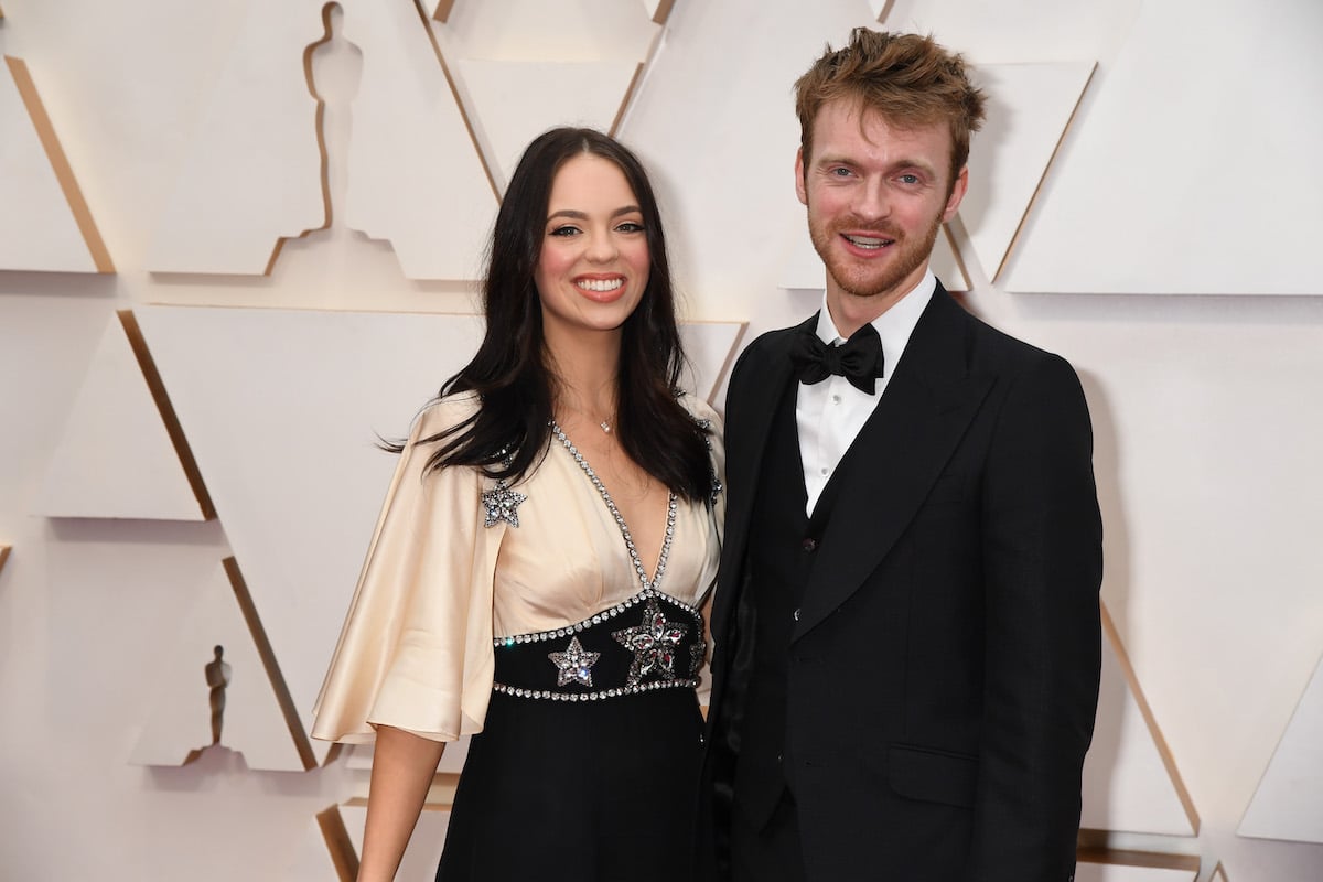 Claudia Sulewski and Finneas O'Connell pose together at an event.