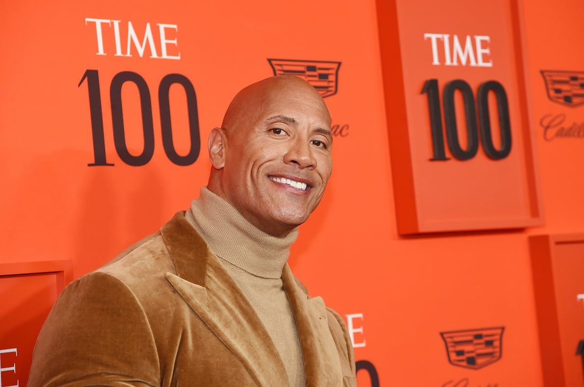 Dwayne Johnson smiling wearing a turtle neck