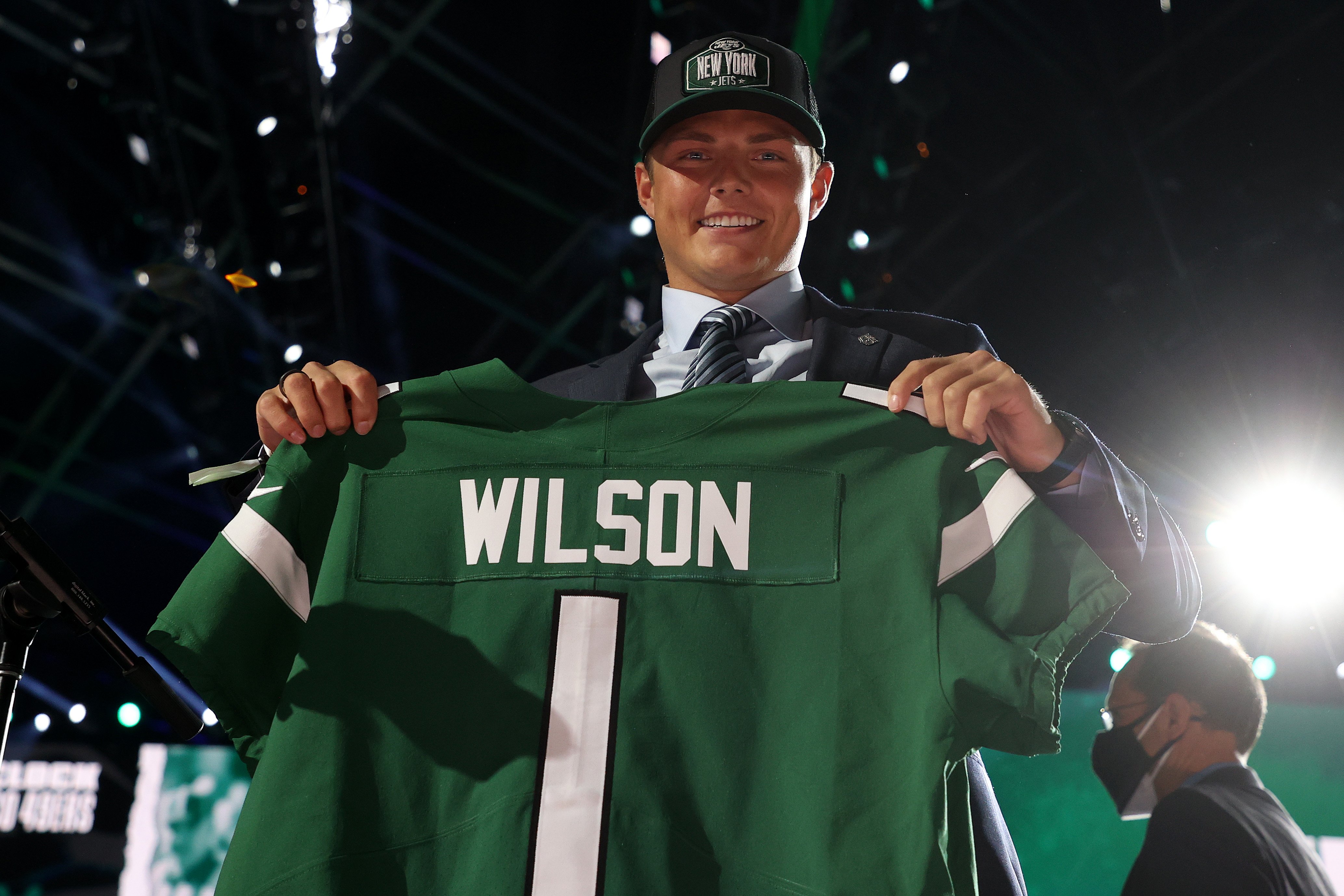 Zach Wilson poses for photo while holding Jets jersey after being drafted on April 29, 2021