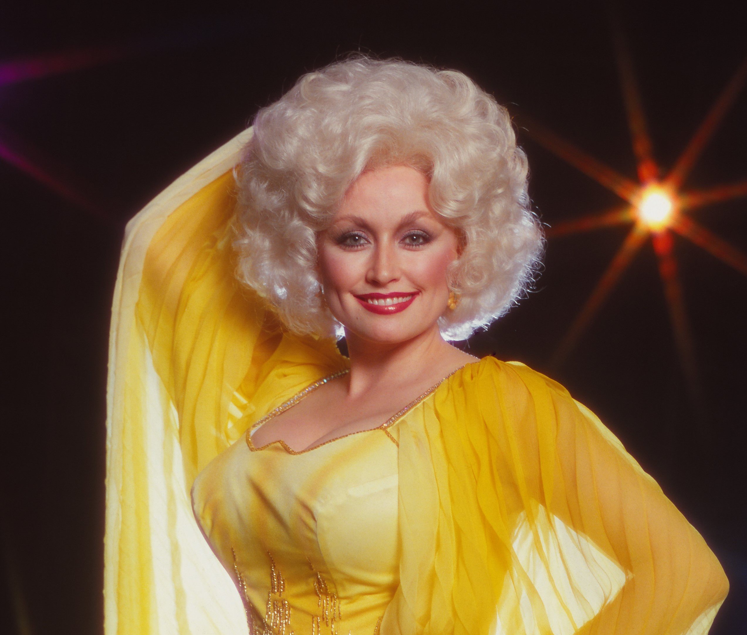 Dolly Parton wearing a sheer yellow dress