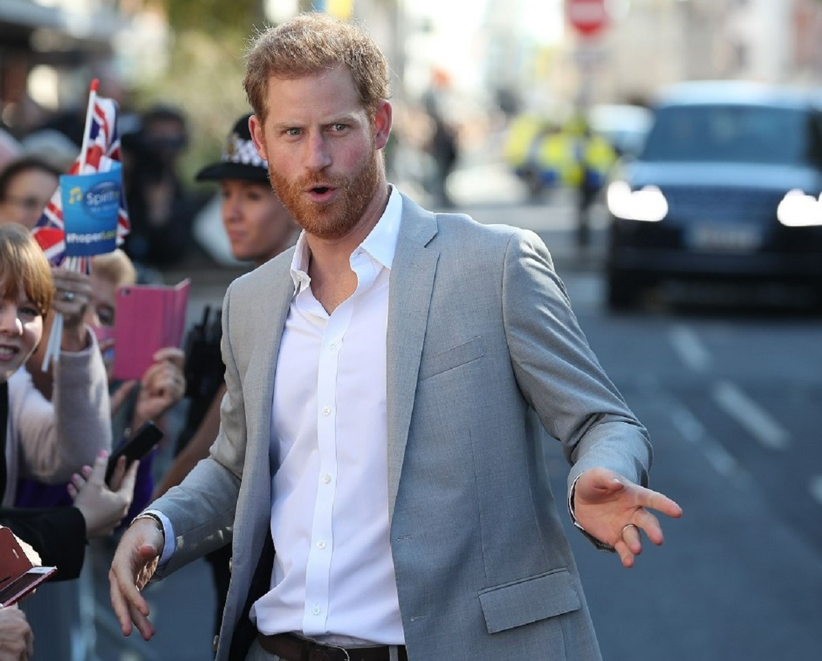 Prince Harry turning towards cameras while greeting fans in Chichester, West Sussex